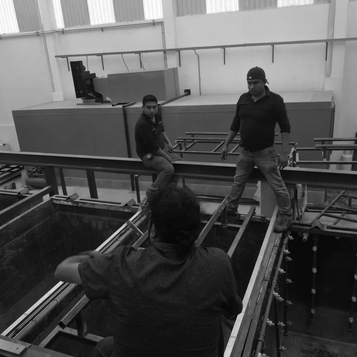 Trabajo de montaje sobre las tinas de proceso de una línea de pintura